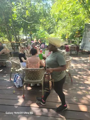 a man standing next to a woman sitting at a table at Rancho Salto Yanigua in El Valle