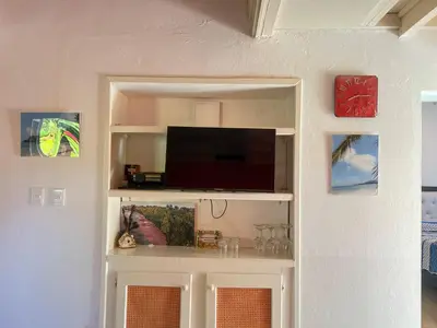 a living room with a tv on a shelf at Mango house bliss in Las Galeras