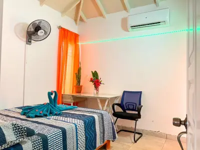 a bedroom with a bed and a desk and a chair at Mango house bliss in Las Galeras