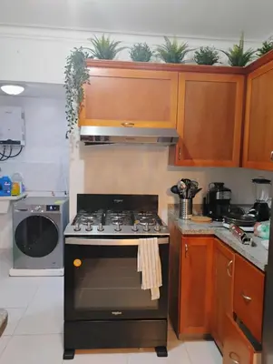 a kitchen with a black stove and wooden cabinets at Amalia Lucero in Mendoza