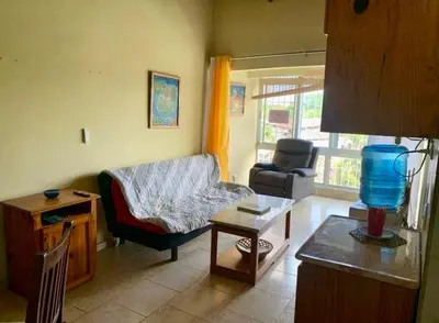 a living room with a couch and a table at Condo Sosúa in Sosúa
