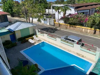 an overhead view of a swimming pool in front of a house at Condo Sosúa in Sosúa