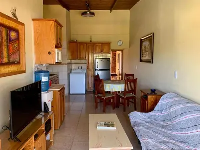a living room with a couch and a kitchen at Condo Sosúa in Sosúa
