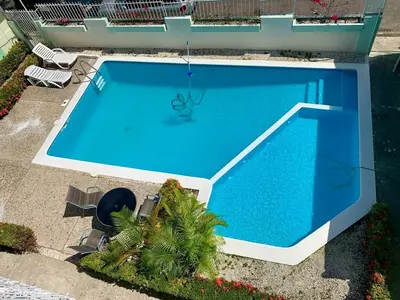 an overhead view of a large blue swimming pool at Condo Sosúa in Sosúa