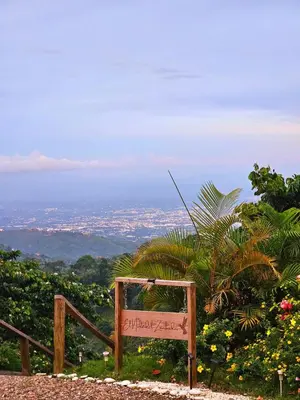 a sign sitting on top of a hill with a city at Pure Nature - Eco-lodge in the Mountains! in La Búcara