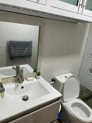 a bathroom with a sink and a toilet and a mirror at Kasita del sol boca chica in Boca Chica