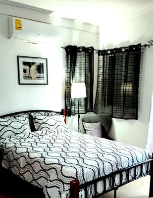 a bedroom with a bed and a lamp at Modern Apartment, Juan Dolio Beach, BlueSea Tower in Villas del Mar