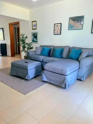 a living room with a blue couch and ottoman at Modern Apartment, Juan Dolio Beach, BlueSea Tower in Villas del Mar