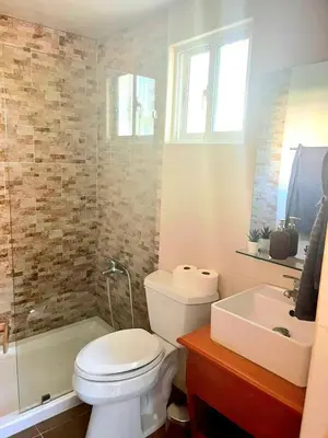 a bathroom with a white toilet and a sink at Modern Apartment, Juan Dolio Beach, BlueSea Tower in Villas del Mar