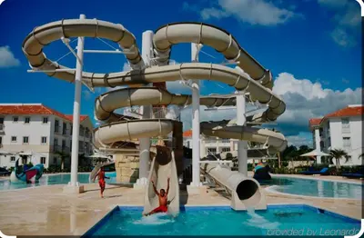 a water slide at a resort with people on it at Luxury sea Cadaques Caribe in Bayahibe