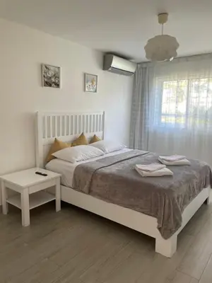 a white bedroom with a large bed and a window at Luxury sea Cadaques Caribe in Bayahibe