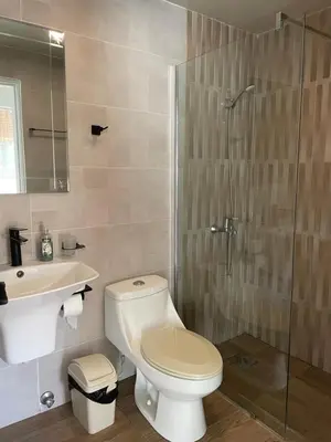 a bathroom with a toilet and a sink and a shower at Luxury sea Cadaques Caribe in Bayahibe