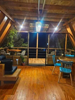 a room with a table and chairs and a large window at Natural Refuge! - Cabin at the top of the mountain in La Búcara