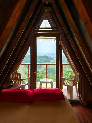 a room with a bed and a large window at Natural Refuge! - Cabin at the top of the mountain in La Búcara