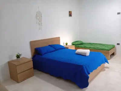 a bedroom with a blue bed and a green mattress at Encuentra tu Alma in Las Terrenas