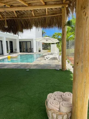 a yard with a swimming pool and an umbrella at Apartamento Entre Playas 3 - 2 pax, 4 min de la playa in Las Galeras