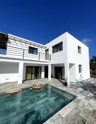 a white house with a swimming pool in front of it at Apartamento Entre Playas 3 - 2 pax, 4 min de la playa in Las Galeras