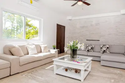 a living room with a couch and a table at Stunning 4 BR Luxury Villa in Punta Cana