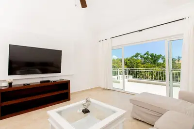 a living room with a tv and a couch at Stunning 4 BR Luxury Villa in Punta Cana