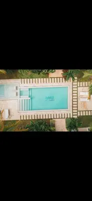 a picture of a swimming pool with a fence at Apartamento en punta cana close to the beach in Punta Cana
