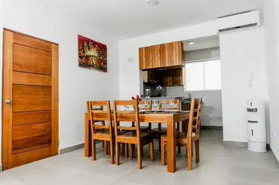 a kitchen with a wooden dining room table and chairs at Caribey2 APT 2D2 in Colorado