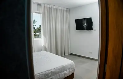a bedroom with a bed and a tv and a window at Caribey2 APT 2D2 in Colorado