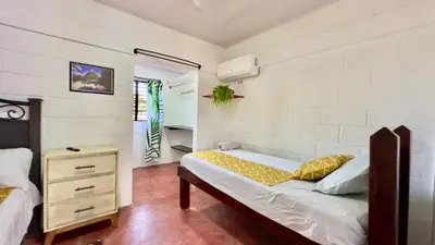 a bedroom with a bed and a dresser in it at Apartamento Mirador de La ciudad in Jarabacoa