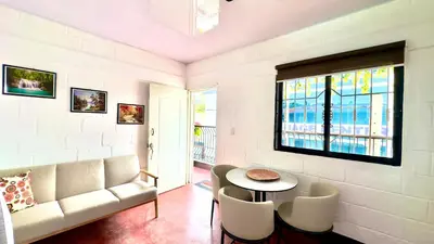 a living room with a couch and a table and chairs at Apartamento Mirador de La ciudad in Jarabacoa