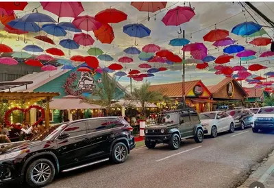 a bunch of umbrellas hanging over a street at Apartamento Mirador de La ciudad in Jarabacoa