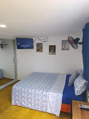 a bedroom with a bed and pictures on the wall at Apart hotel Costa Verde#7 con cama Queen in Las Galeras