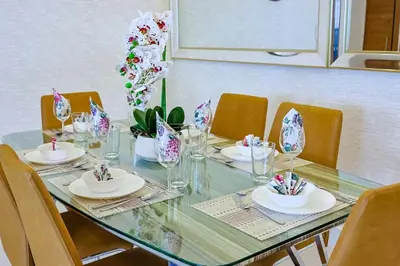 a table with chairs and plates and glasses on it at Elegant Centric Apt Near all in Santo Domingo