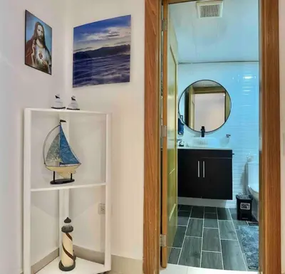 a bathroom with a sink and a mirror at Cozy Beach Condo Great Views in Guayacanes