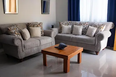 a living room with two couches and a coffee table at Sol, playa y arena, Casa cerca de la playa in San Felipe de Puerto Plata
