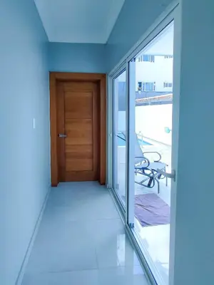 an empty room with a door and a balcony at Sol, playa y arena, Casa cerca de la playa in San Felipe de Puerto Plata