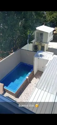 a swimming pool on the roof of a house at Apart-hotel Central in Las Terrenas
