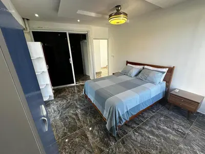 a bedroom with a bed and a large window at Apart-hotel Central in Las Terrenas