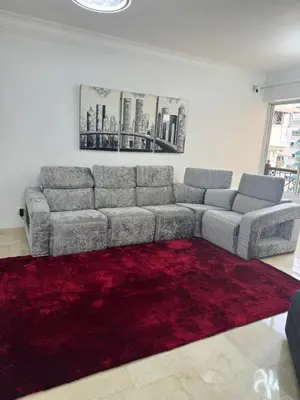 a living room with a couch and a red rug at Torre DOÑA EVA in Santo Domingo