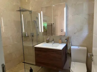 a bathroom with a sink and a shower and a toilet at Villa paraíso in Juan Dolio