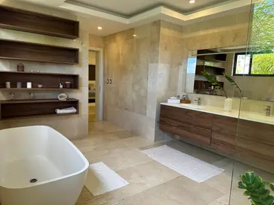 a large bathroom with a tub and a sink at Villa paraíso in Juan Dolio