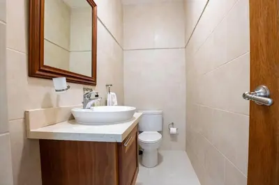 a bathroom with a sink and a toilet at Pro Cab Paradise Condos Cabarete in Cabarete