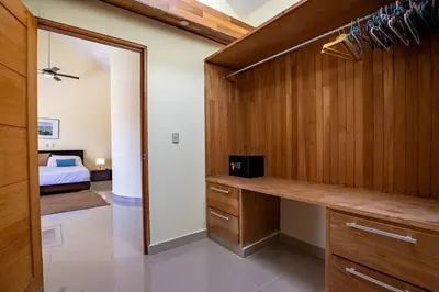 a bedroom with a bed and a dressing room at Pro Cab Paradise Condos Cabarete in Cabarete