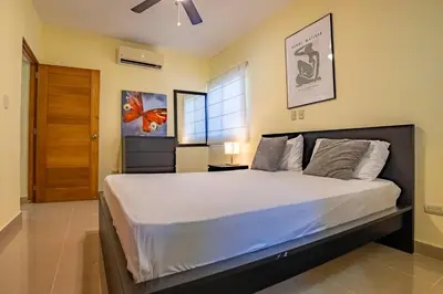 a bedroom with a large bed in a room at Pro Cab Paradise Condos Cabarete in Cabarete