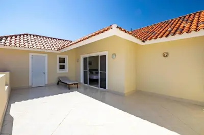 a home with a tile roof at Pro Cab Paradise Condos Cabarete in Cabarete