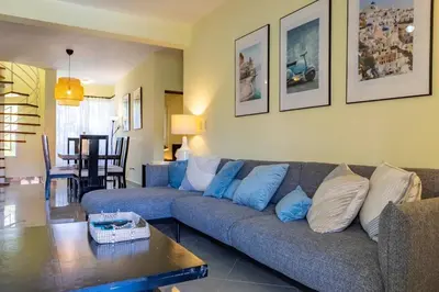 a living room with a couch and a table at Pro Cab Paradise Condos Cabarete in Cabarete