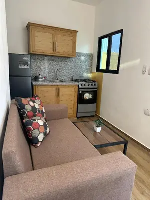 a living room with a couch and a kitchen at Residencial Fe y Esperanza in Pedernales