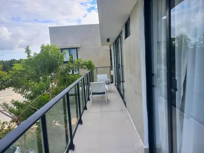 a balcony with a table and chairs on a building at Apartamento en Vista Cana in Batey San Germán