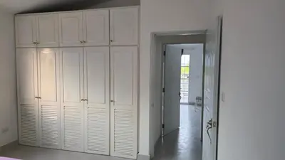 an empty room with white cabinets and a doorway at Acogedora Casa privada in Bayahibe