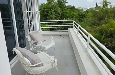 a couple of chairs sitting on a balcony at Acogedora Casa privada in Bayahibe