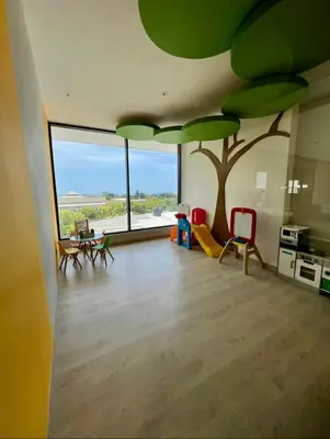 a living room with a tree mural on the wall at Comfortable apartmento en el centro de la ciudad con piscina y gym in Santo Domingo