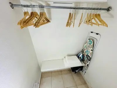 a room with a white wall with a bench and chopsticks at Central, a 5 Minutos de Playa, AC, Piscina, Cómodo, Bares, Rest in Sosúa